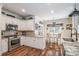 Well-appointed kitchen with stainless steel appliances, granite countertops, white cabinetry, and breakfast nook area at 1522 12Th Fairway Nw Dr, Concord, NC 28027