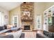 Inviting living room with a floor-to-ceiling stone fireplace, built-in shelving and large windows for natural light at 1522 12Th Fairway Nw Dr, Concord, NC 28027