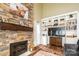 Stylish living room with a stone fireplace, custom built-in shelving, and neutral color scheme at 1522 12Th Fairway Nw Dr, Concord, NC 28027