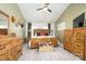 This beautiful main bedroom features a vaulted ceiling, exposed wood furnishings and a ceiling fan at 1522 12Th Fairway Nw Dr, Concord, NC 28027