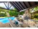 Outdoor fireplace and patio area by pool provide an inviting space for relaxation and outdoor gatherings at 1522 12Th Fairway Nw Dr, Concord, NC 28027