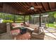 A cozy outdoor seating area with neutral furnishings, overhead fans, and a fire pit at 1522 12Th Fairway Nw Dr, Concord, NC 28027