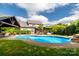 Backyard oasis featuring a pool, covered patio, and manicured landscaping perfect for outdoor entertaining at 1522 12Th Fairway Nw Dr, Concord, NC 28027