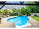 A backyard pool with a waterfall feature and a cabana offers a relaxing outdoor retreat at 1522 12Th Fairway Nw Dr, Concord, NC 28027
