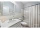 Cozy bathroom featuring single sink vanity, framed mirror, and tub with shower combo at 15515 Laverack Ln, Davidson, NC 28036