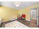 Bright, colorful bedroom features hardwood floors, area rug, and ample natural light at 15515 Laverack Ln, Davidson, NC 28036