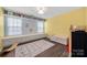 Unique bedroom with built-in shelves and window seat plus decorative rug on hardwood floors at 15515 Laverack Ln, Davidson, NC 28036