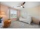 Cozy bedroom featuring a ceiling fan and a window providing natural light at 15515 Laverack Ln, Davidson, NC 28036
