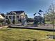 Community playground with climbing wall, play structure, and grassy play area in front of multi-story home at 15515 Laverack Ln, Davidson, NC 28036