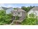 Charming two-story home with a covered front porch and well-manicured landscaping at 15515 Laverack Ln, Davidson, NC 28036