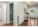Bright foyer with hardwood floors, decorative mirror, and convenient access to powder room at 15515 Laverack Ln, Davidson, NC 28036