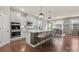 Bright kitchen features a large center island with seating and pendant lighting at 15515 Laverack Ln, Davidson, NC 28036
