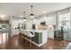 Modern kitchen with white cabinets, stainless steel appliances, and a spacious island with seating at 15515 Laverack Ln, Davidson, NC 28036