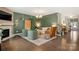 Comfortable living room featuring a fireplace, hardwood floors, and modern decor elements at 15515 Laverack Ln, Davidson, NC 28036