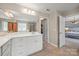 Spacious main bathroom featuring double sinks, large mirror, and glass enclosed shower at 15515 Laverack Ln, Davidson, NC 28036