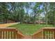 Large backyard view from deck, featuring a new fence and mature trees for privacy and outdoor enjoyment at 1626 Burtonwood Cir, Charlotte, NC 28212