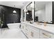 Elegant bathroom with double sinks, white cabinetry, and black-framed mirrors for a contemporary feel at 1626 Burtonwood Cir, Charlotte, NC 28212