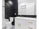Clean bathroom showcasing dark tiled walls, and white vanity with gold hardware at 1626 Burtonwood Cir, Charlotte, NC 28212