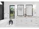 Bright bathroom featuring double vanity, black framed mirrors and a soaking tub at 1626 Burtonwood Cir, Charlotte, NC 28212