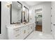 Bright bathroom featuring double vanity, modern lighting fixtures, and access to walk-in closet at 1626 Burtonwood Cir, Charlotte, NC 28212