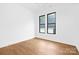 Bright bedroom with hardwood floors and two large windows providing views of the neighborhood at 1626 Burtonwood Cir, Charlotte, NC 28212