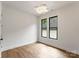 Light and airy bedroom with wood floors, modern lighting, and black frame windows at 1626 Burtonwood Cir, Charlotte, NC 28212