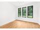 Bedroom with hardwood floors and large windows that provide ample natural light at 1626 Burtonwood Cir, Charlotte, NC 28212