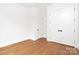 Bedroom featuring hardwood floors, neutral walls and trim, closet and interior door at 1626 Burtonwood Cir, Charlotte, NC 28212