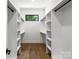 Walk-in closet provides ample storage with built-in shelving and rods for organized wardrobe at 1626 Burtonwood Cir, Charlotte, NC 28212