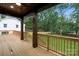 The covered backyard wooden deck overlooks the yard at 1626 Burtonwood Cir, Charlotte, NC 28212