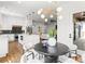 Dining area with modern lighting, and view to the open concept kitchen and living area with fireplace feature at 1626 Burtonwood Cir, Charlotte, NC 28212
