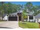 Attractive one-story house featuring a black garage door, landscaped yard, and a welcoming entrance with modern design elements at 1626 Burtonwood Cir, Charlotte, NC 28212