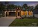 Charming single-story home boasting a well-manicured lawn, modern garage door, and inviting front entrance with decorative pillars at 1626 Burtonwood Cir, Charlotte, NC 28212