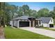 Inviting single-Gathering home with a well-kept lawn, stylish garage door, and a contemporary front entrance design at 1626 Burtonwood Cir, Charlotte, NC 28212