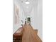 Bright hallway with hardwood floors, white walls, modern art, and views of the living area and natural light at 1626 Burtonwood Cir, Charlotte, NC 28212