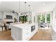 Spacious kitchen with a large island, stainless steel appliances, connected to dining and living space with fireplace feature at 1626 Burtonwood Cir, Charlotte, NC 28212