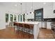 Modern kitchen featuring a large island, stainless steel appliances, pendant lighting, and stylish bar stool seating at 1626 Burtonwood Cir, Charlotte, NC 28212