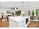 Bright kitchen with an island featuring gold hardware and view into the living room at 1626 Burtonwood Cir, Charlotte, NC 28212