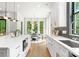 Beautiful kitchen with a large island and stainless steel appliances adjoining a bright dining area with floor to ceiling windows at 1626 Burtonwood Cir, Charlotte, NC 28212