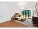 Bedroom with hardwood floors, modern lighting and access to a private outdoor deck at 1626 Burtonwood Cir, Charlotte, NC 28212