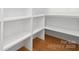 Bright pantry with custom shelving and hardwood floors at 1626 Burtonwood Cir, Charlotte, NC 28212