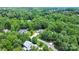 Aerial view of a home nestled among lush, mature trees in a serene neighborhood at 167 Logan Crossing Dr, Davidson, NC 28036