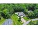 Aerial view featuring a home with lush greenery, landscaped yard, and a private pool area at 167 Logan Crossing Dr, Davidson, NC 28036