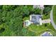 Aerial view of a home with a private pool and spacious backyard surrounded by lush greenery at 167 Logan Crossing Dr, Davidson, NC 28036