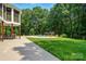 The expansive backyard includes a large swimming pool, patio, lush lawn, and mature trees at 167 Logan Crossing Dr, Davidson, NC 28036