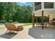 The backyard boasts a pool, patio, lush lawn, a fire pit, and mature trees for privacy at 167 Logan Crossing Dr, Davidson, NC 28036