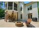 Exterior of this home shows a sprawling backyard with patio, fire pit, and lush green landscaping at 167 Logan Crossing Dr, Davidson, NC 28036