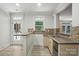 Chic bar area with a sink, wine fridge, granite countertops, natural light, and outside access to the pool at 167 Logan Crossing Dr, Davidson, NC 28036