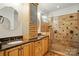 Luxury bathroom features double sinks, granite countertop, ample cabinetry, and a tiled walk-in shower at 167 Logan Crossing Dr, Davidson, NC 28036
