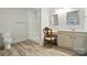 This bright bathroom has a single sink vanity and a walk-in shower with a white surround at 167 Logan Crossing Dr, Davidson, NC 28036